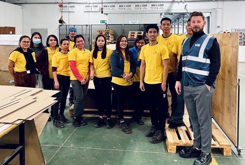 Twin Star workers on shift at the plant they were placed at, with their supervisor