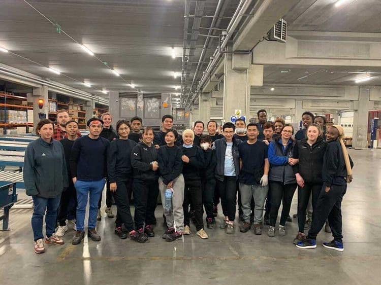 Twin Star workers in workwear on a plant floor with their colleagues