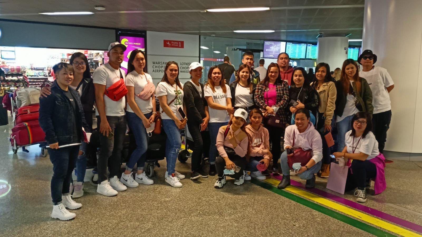 Twin Star applicants in the arrivals hall at Warsaw Chopin Airport
